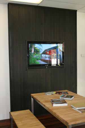TV Monitor encased in dark timber lined wall for maximum effect. The dar coloured wall cladding being perfection for this situation
