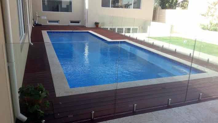 Jarrah hardwood decking as pool suuround - with glass screens