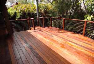 Raised hardwood deck with stainless steel wire fencing surrounds